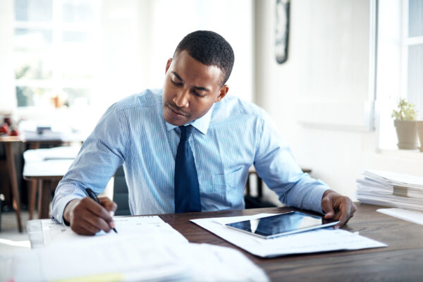black man working in an office in a suit