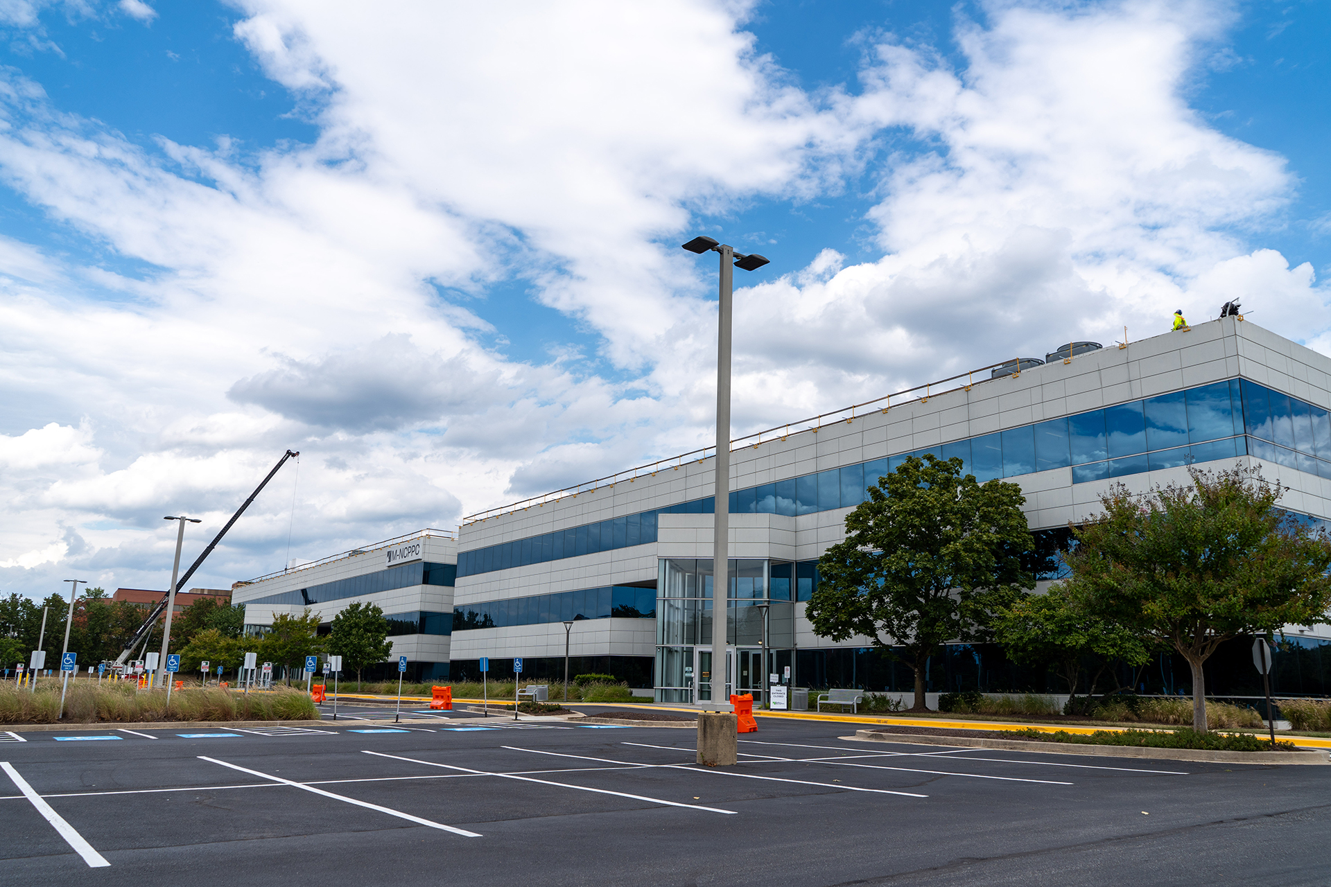 Construction crane looms over the M-NCPPC Largo Headquarters during the first phase of needed building updates.